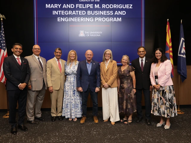 A mix of people in professional clothing stand in front of a sign reading "The Mary and Felipe M. Rodriguez Integrated Business and Engineering program."