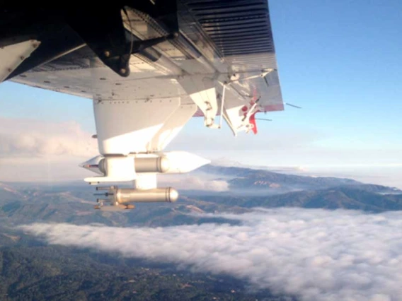Photo taken from inside an airplane flying above the cloud layer.