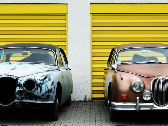 photo of old car next to new car