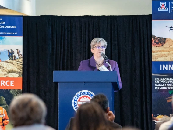 Mary Poulton speaking from podium