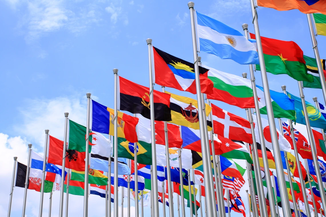 Flags from several countries fly on poles