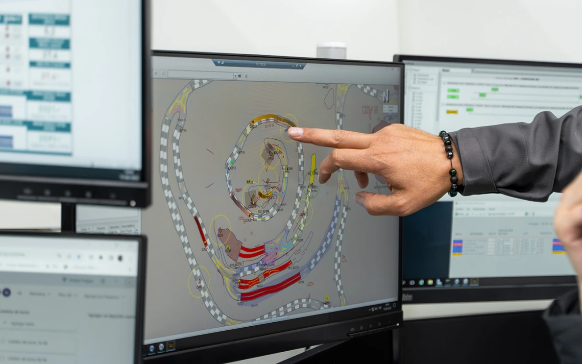 A person points at a computer screen.