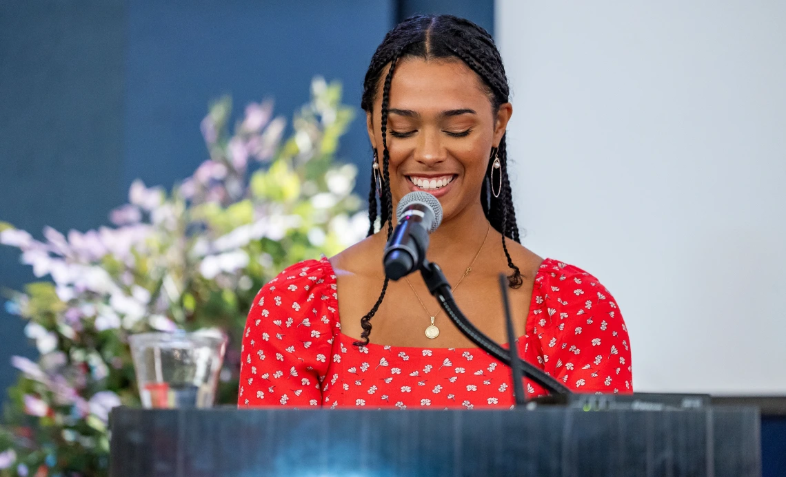 Aaliyah Thompson-Mazzeo speaks at a podium.