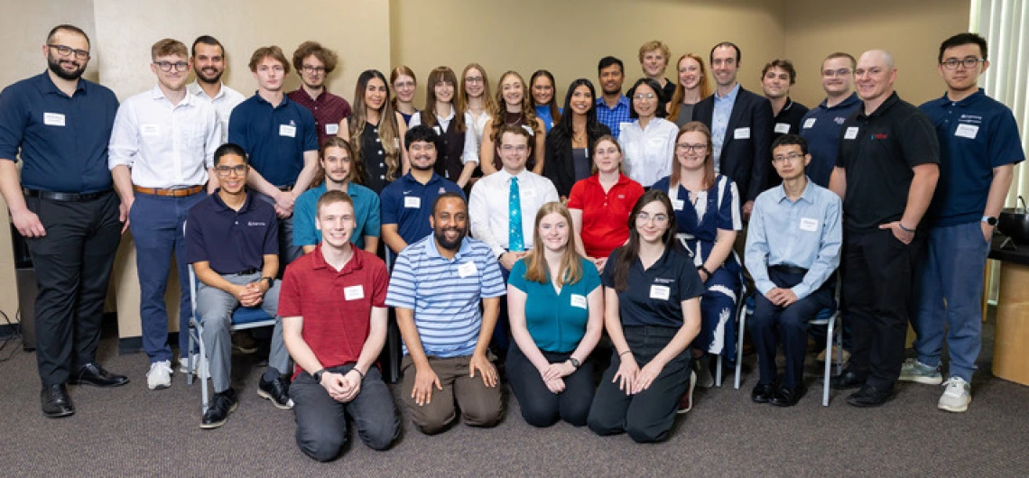 A large group of students and teaching assistants poses in the SUMC on the University of Arizona campus.
