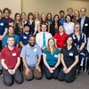 A large group of students and teaching assistants poses in the SUMC on the University of Arizona campus.